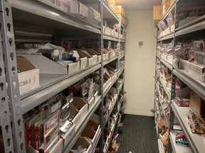 Shelves stocked with model cars and toys in a retail store aisle for Bryans Bargains Bargain 18