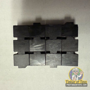 Twelve black, rectangular traction magnets arranged in three rows of four for Tyco 16310