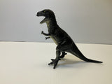 Black T-Rex dinosaur toy figure standing on a white surface for Mamejo MAJ33000
