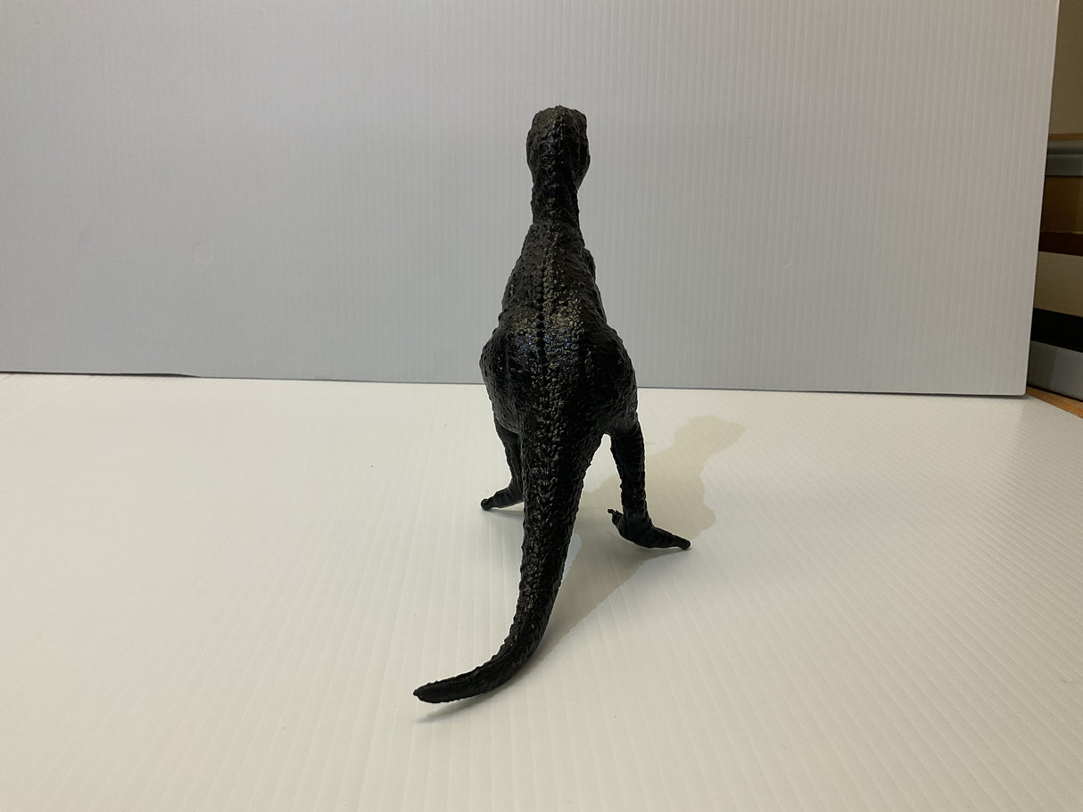 Black T-Rex dinosaur model standing on a white surface for Mamejo MAJ33000, rear view