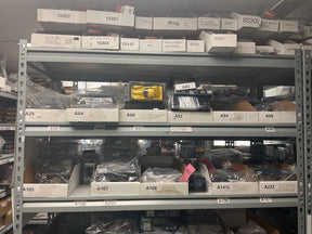 Shelves stacked with assorted 1/32 scale slot cars and toy parts for Bryans Bargains Bargain 8