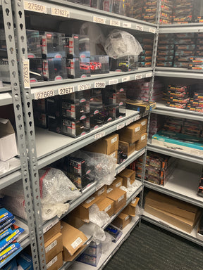Shelves stocked with assorted Carrera 1/32 scale race cars for Bryans Bargains Bargain 13.5
