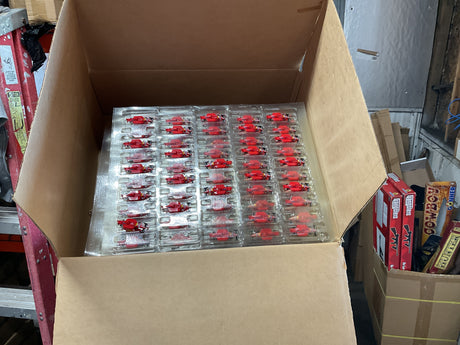 Case of small, red, slot car race car bodies for Tyco B9969 case