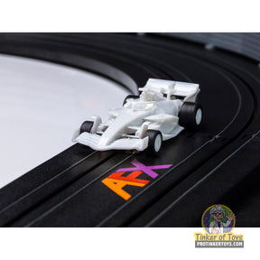 White race car toy on a black track with orange and yellow lettering for AFX/Racemasters 22089