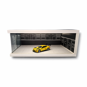 Yellow diecast car displayed in a black and white light-up parking garage scene for Shou Cang Jia IMX2572