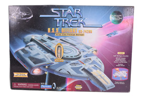 Toy box art featuring the Star Trek U.S.S. Defiant starship model for Playmates 16140