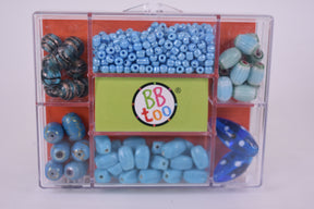 Assortment of ocean blue glass beads in a clear storage case for BBTOO 936