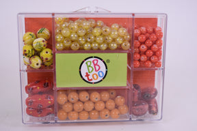 Assortment of colorful beads in a clear, compartmentalized bead kit for BBTOO 934