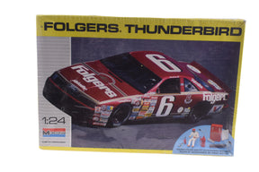Model kit of a red and black Thunderbird race car with driver figure and accessories for Monogram 2928