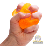 Orange, gummy toy held in an open hand for Schylling GDND