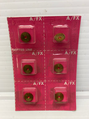 Brass idler gears mounted on a pink backing card for racing parts for Aurora /AFX Racing 8319