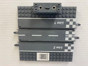 Racing track sections for micro slot cars, labeled Line 1 and Line 2 for Jupiter Creations G9201