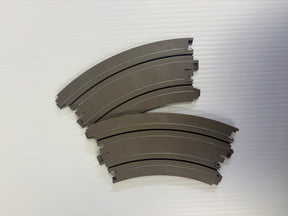 Curved, dark gray off-road bumper pieces, stacked on a white surface for Auto World H0047-OF