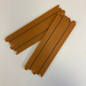 Two sets of brown, straight toy train tracks laid out on a white surface for Auto World H006-D