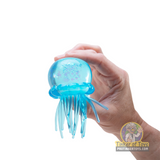 Blue, squishy jellyfish toy held in a hand against white background for Nee Doh JSND