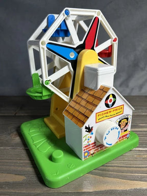 Colorful, spinning Ferris wheel toy with a small house base for Schylling 2077