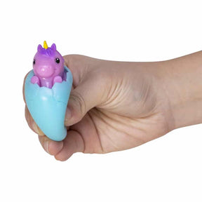 Small, pink unicorn peeking from a light blue, squishy egg for Schylling USPH