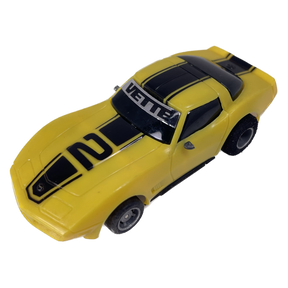 Yellow toy Corvette with black racing stripes, 1979 model for Tyco B8917