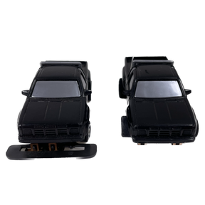 Two black vintage toy pickup trucks, front view, for collection for Tyco B30004