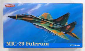 Model kit box art: Green and orange fighter jet against a blue sky for Kangnam Model