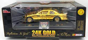 Gold die-cast model car in its display box for Racing Champion 2424