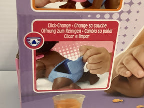 Toy box showing a child changing a diaper on a doll
