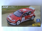 Red Peugeot 206WRC 1:43 scale model car on a display card for Heller