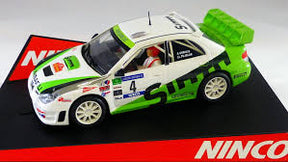 White and green Subaru rally car toy, featuring racing decals and a spare tire for Ninco 50451
