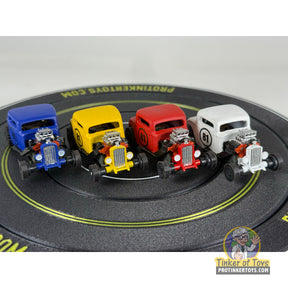 Four slot car hot rod cars in blue, yellow, red, and white for Extreme 3D Customs Extreme 3D Customs