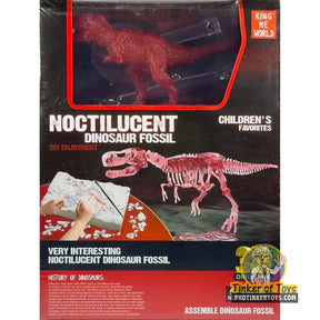 Dinosaur fossil assembly kit showing a red T-Rex figure and skeleton pieces for King Me World IMX17221
