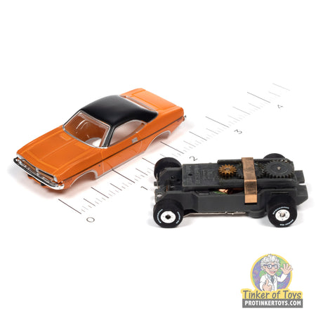 Orange 1970 Plymouth Barracuda toy car next to a black toy car for Auto World SC390