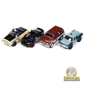 Four toy police cars: yellow, black, maroon, and blue for Auto World SC397