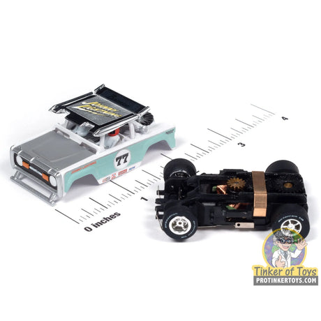 Xtraction 1972 Ford Baja Bronco (White with Light Teal Race Graphics) 1B | SC407 | Auto World — chassis and scale view
