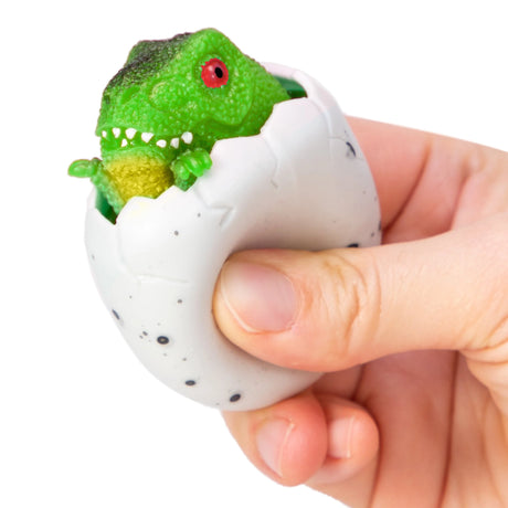 Squeezy Egg Popper toy in hand, squeezed and green dino popping out