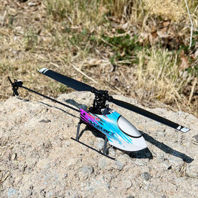 Blue and black micro helicopter on a rock outdoors for Rage R/C RGR6002