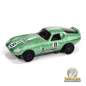 Metallic green slot car of a 1965 Shelby Cobra Daytona Coupe for Auto World SC415