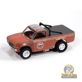 Rusty red 1972 Datsun 620 pickup truck toy for Auto World SC418