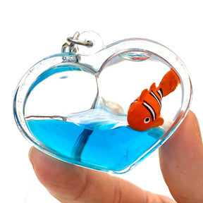 Heart-shaped charm with blue water and a small orange fish figurine for Bcmini 12060