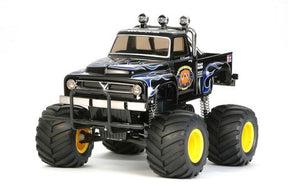 Black RC crawler truck with large tires and chrome accents for Tamiya Models 58547-A