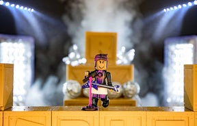 Action figure on stage with microphone, set against bright spotlights for UCC 19829