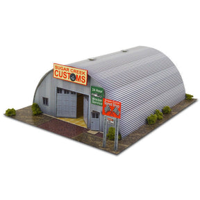 Model kit of a curved, corrugated metal building with signage for Innovative Hobby Supply BK6400
