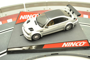 Silver and black BMW M3 GTR race car model on a track base for Ninco 50269