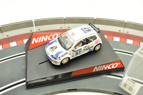 Slot car of a white Fiat Punto race car on a track base for Ninco 50298