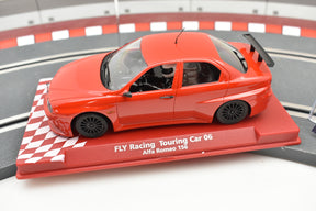Red slot car of an Alfa Romeo 156 on a track base for Fly Car 88243