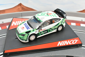 Green and white race car model on a black base for Ninco 50441