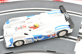 White and blue scale model of an Audi R10 TDI race car on a track for SCX A10300X3U0