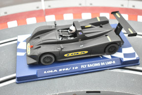 Black and yellow race car model on a blue and white checkered base for Fly Car 07059, front view