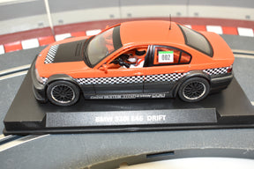 Orange slot car, BMW 320i E46, on a black display base for Fly Car 88254