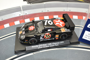 Black Porsche race car model, 76, on display stand for Fly Car GB71L