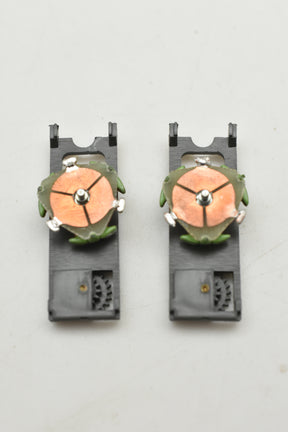 Two green and orange top plate assemblies for a model train for Aurora AFX 1750-061